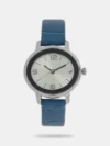 This analog watch for girls contains a silver, oval dial, housed in a Metal case that has a crown attached. Three plain hands, along with two Arabic numeral markings are present on the dial. Its purple strap, made of leather, has an adjustable metal buckle closure.