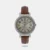 This analog watch for women has a round, White dial. Featuring three plain hands and markings at quarter intervals, the dial is housed within a Silver colour case that has a crown. Made of leather, its brown strap is fitted with a buckle closure for maximum comfort.