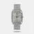 For a refined look, opt for this rectangular silver-white dial watch for men. The Roman numerals, day and date display, and stainless steel strap with a special three-piece sliding clasp add sophistication. The watch is a true embodiment of timeless elegance. To highlight its classic appeal, style it with a tailored suit, creating a look that is both formal and sophisticated for various occasions.