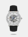 Independent design meets exceptional functionality in this watch. The steel case features a balanced matte and smooth finish, enclosing a guilloche dial with a transparent window and the brand logo. Applied hour markers combine strokes and Roman numerals, while leaf-shaped feuille hands with luminescent coating ensure visibility in the dark after exposure to light. A fluted crown with protective detailing enhances durability. The comfortable leather strap and secure clasp complete the design with reliable craftsmanship.