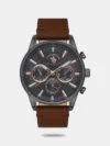 Taken from Santa Barbara Polo & Racquet Club, this men's analog watch is an exquisite timepiece that merges practicality with contemporary style. Its genuine leather strap flaunts a brown hue that accentuates the look of the watch. Safeguarded by a mineral glass and operated by a quartz movement, the round blue dial is encompassed in a 44 mm case. It features plain three hands and a crown for time adjustment. Besides, it is completed with a buckle clasp to ensure a secure fit on the wrist.
