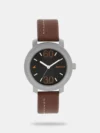 This analog watch for girls has a round, black dial, featuring two plain hands, three subdials and markings at the quarter intervals. A crown on the case lets you adjust the time. Made of leather, its black strap is fitted with a buckle closure.