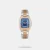 Amaze everyone around you by wearing this women's analog watch from the collection by Lee Cooper. Encased in a 41 mm case, the blue tonneau dial is protected by a mineral glass. It features plain three hands. The stainless steel strap comes in a two tone hue that further elevates the look of the watch. Besides, it is completed with a push-button clasp to ensure a secure fit on the wrist.