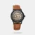 Complement your personality with this men's analog watch from the Automatic collection by Titan. Enclosed in a 56 mm case, the black round dial looks quite attractive. It displays plain three hands and a crown for time adjustment. The genuine leather strap showcases a brown hue that uplifts the look of the watch. Besides, it is completed with a buckle clasp to ensure a secure fit on the wrist.