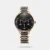 Elevate your evenings with this timepiece featuring an all-black dial, multifunction sub-dials, and sleek gold indices and hands. The watch boasts a gold shining case and a dual-tone solid stainless steel bracelet with gold and black ceramic links, culminating in a modern design with chic ceramic allure. Perfect for nights, pair this watch with a crisp black suit for a sophisticated and stylish look.