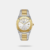 The Tornado Aurora Twilight T23003-TBTW is a premium men's analog watch featuring a 42mm silver and gold-tone stainless steel case with an elegant octagonal bezel. It showcases a minimalist white dial with a date window, protected by scratch-resistant sapphire crystal. Powered by a reliable Japanese Miyota quartz movement, this luxurious timepiece is built with an integrated two-tone bracelet and offers 100-meter water resistance.