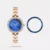 The Timex Fria TWEL29200 is an elegant, vintage-inspired women's analog watch featuring a 33mm blue dial and a rose gold-tone brass strap. It is uniquely designed with interchangeable bezel rings, allowing you to easily switch up your style for any occasion. Powered by a reliable quartz movement, it is lightweight at 50g and water-resistant up to 30 meters