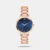 The Timex Trendline TWTL12310 is an elegant women's analog watch featuring a classic 32mm round blue dial housed in a durable brass case. It comes styled with a sophisticated 14mm rose gold stainless steel mesh strap secured by a push-button clasp. Powered by a precise quartz movement and protected by mineral glass, this timepiece offers 3 ATM water resistance, making it both a stylish and durable accessory for everyday wear.