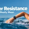 Swimmer wearing a black water-resistant sports watch in open ocean water - Watch Palace guide